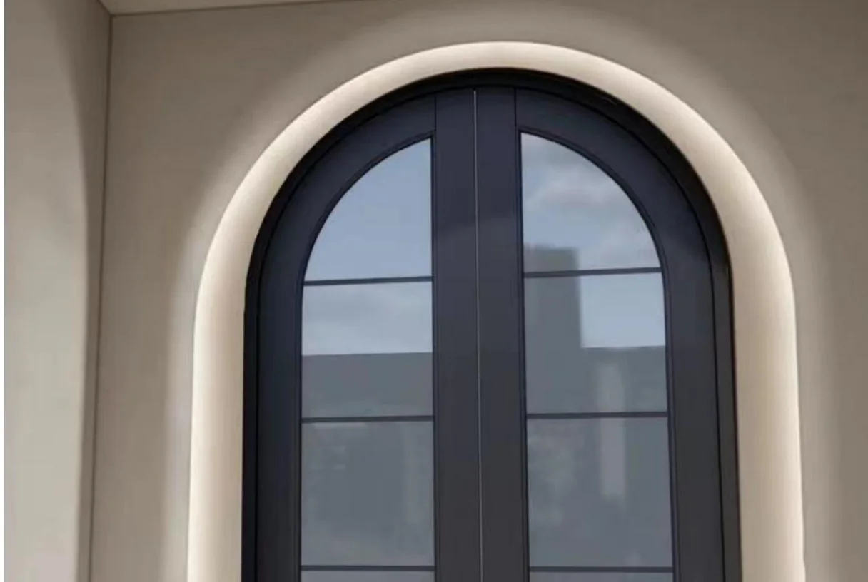 Dark aluminium arc entrance door with glass panes set under a smooth stucco arch, design rendering