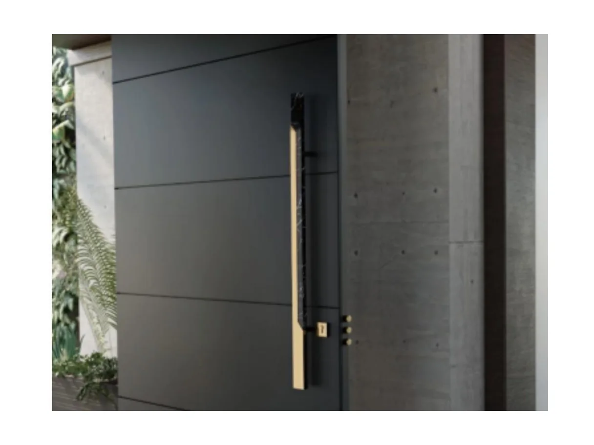 Front view of a concrete-grey aluminium offset-hinge entrance leaf with a vertical brass pull