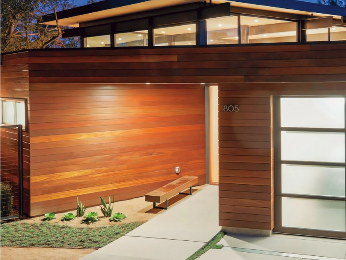 Aluminium glass panel garage door seen from inside a lit garage, design rendering