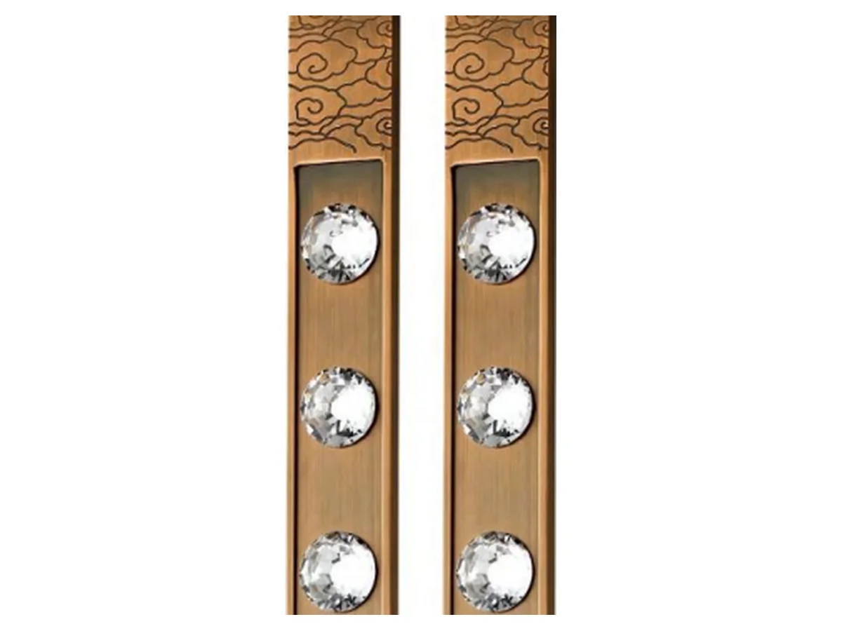 Close-up product shot of the ring-knob form and mount of an ornate brass door handle