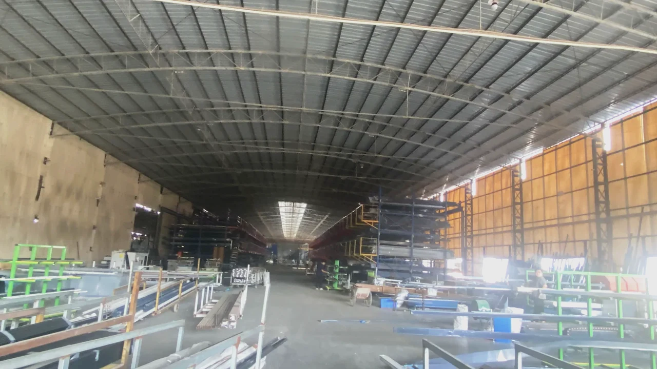 Extrusion hall interior with overhead crane and production lines running the length of the plant