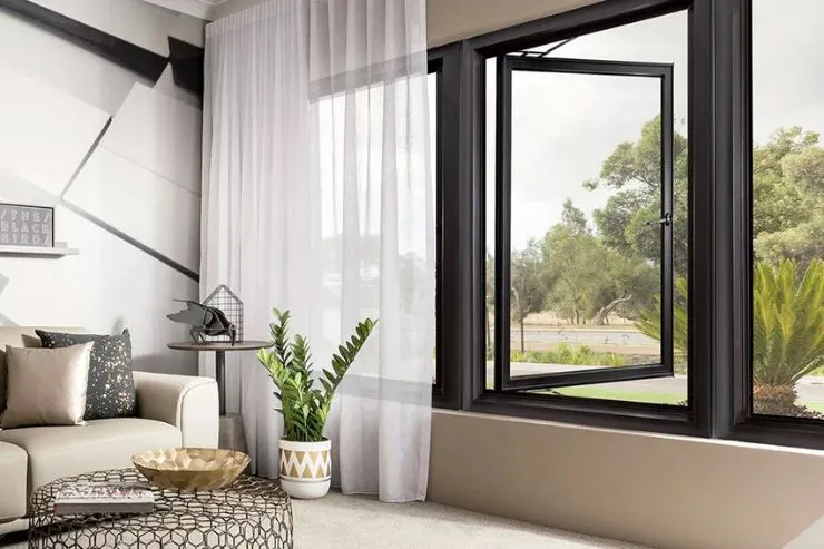 Open black aluminium casement sash in a modern living room with sheer curtains